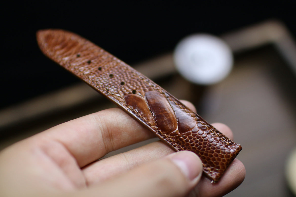 Close-up of hand-burnished ostrich leg scales on the watch strap
